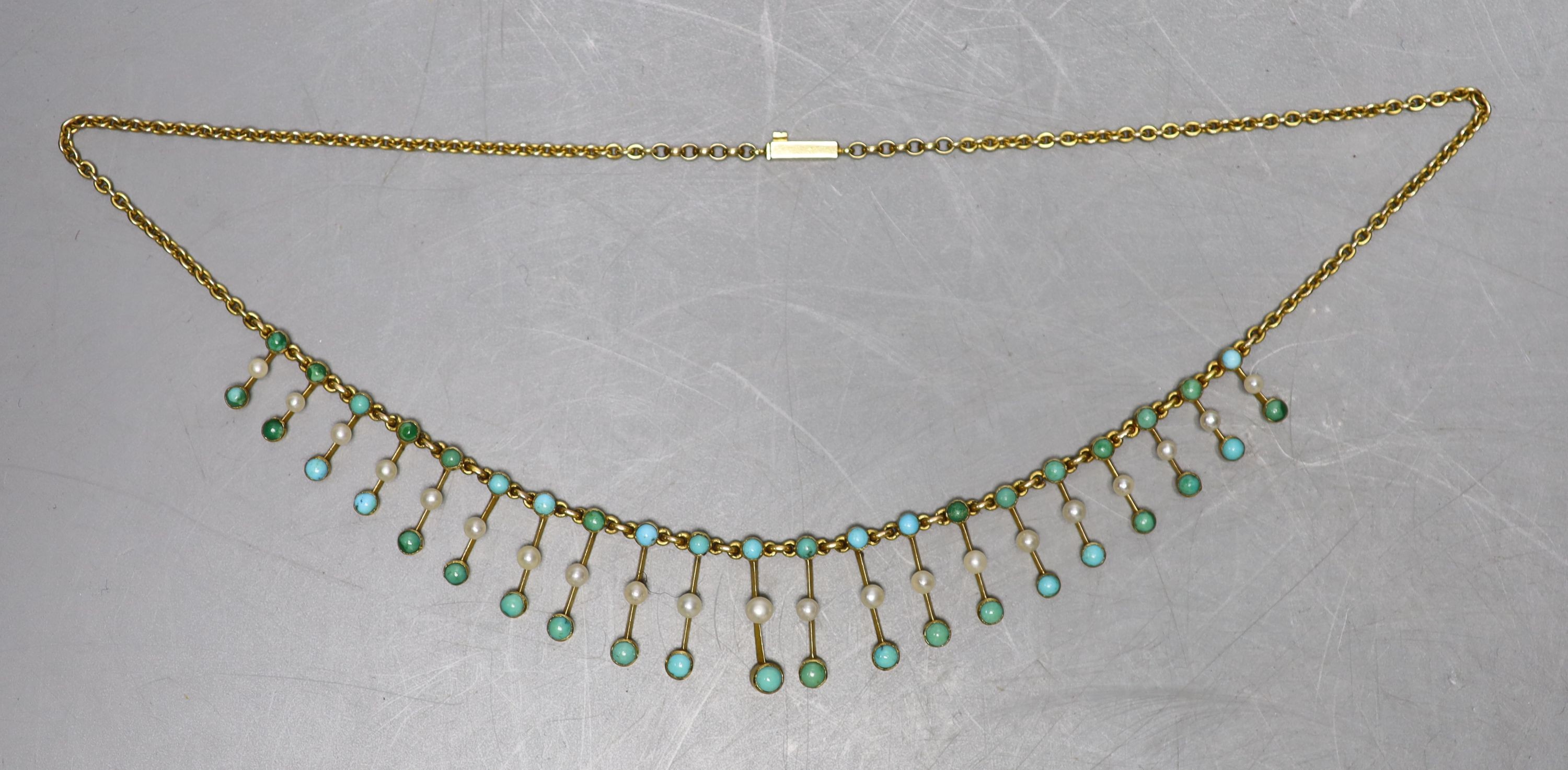 An Edwardian yellow metal, seed pearl and turquoise set fringe necklace, 42cm, gross weight 15.2 grams.